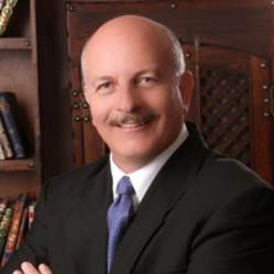A person in a suit and tie Description automatically generated with medium confidence